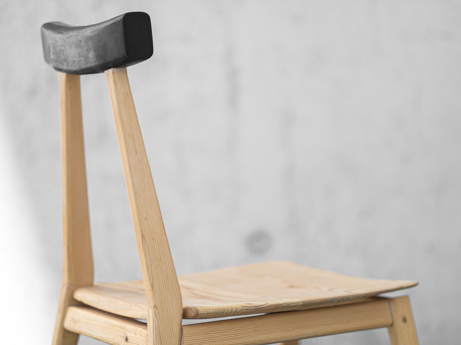 Ryoku — detail of the cast rubber backrest slotted onto the two rear legs.