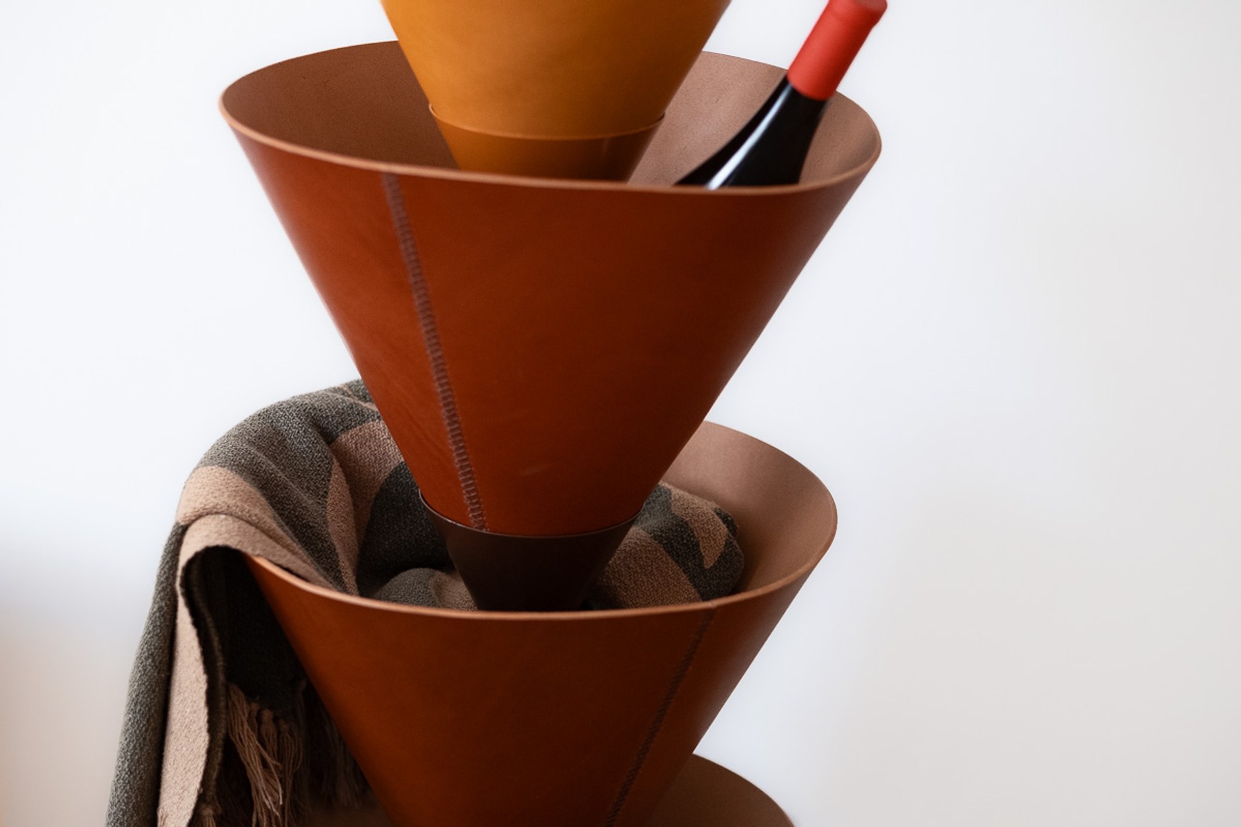 House Palm by NOEMAR — stylised palm-tree shelf of stacked leather cones on a central mast. Wiener Norm collection, 2026 (view 3 of 8).