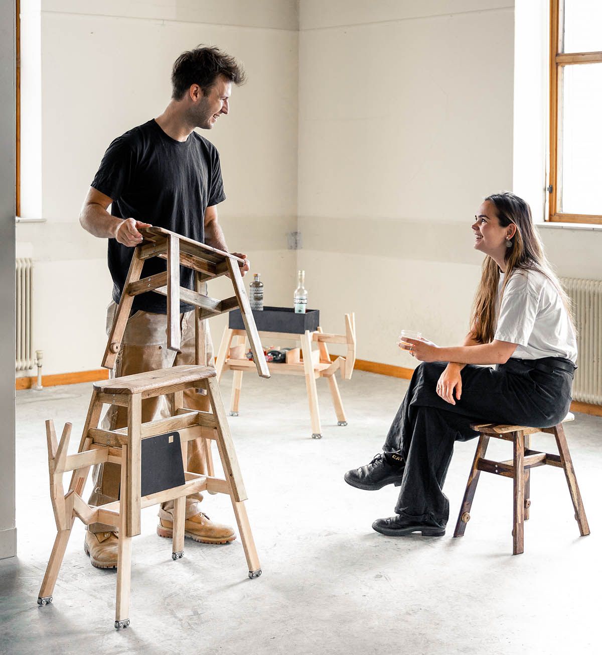 Marcel and Noelani in conversation, seated on Würstelhocker stools in the studio.