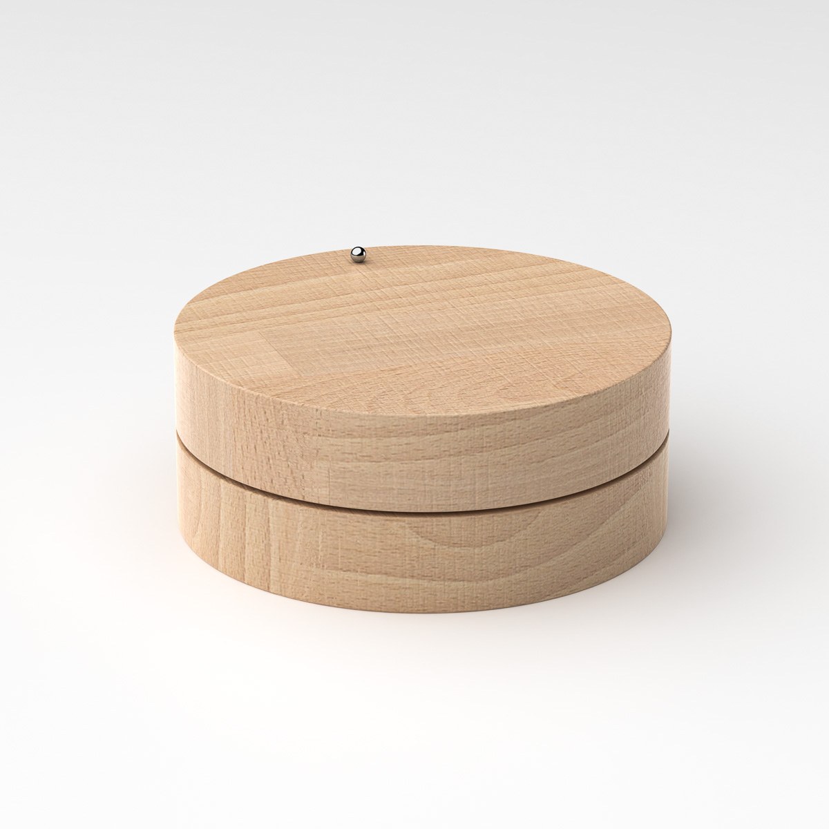 Toki by NOEMAR — studio view of the wooden disc with the ball near the top edge.
