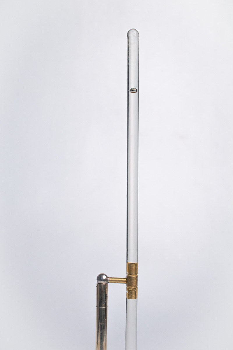 In Limbo — detail of the glass rod's hinge joint and the brass ball counterweight.