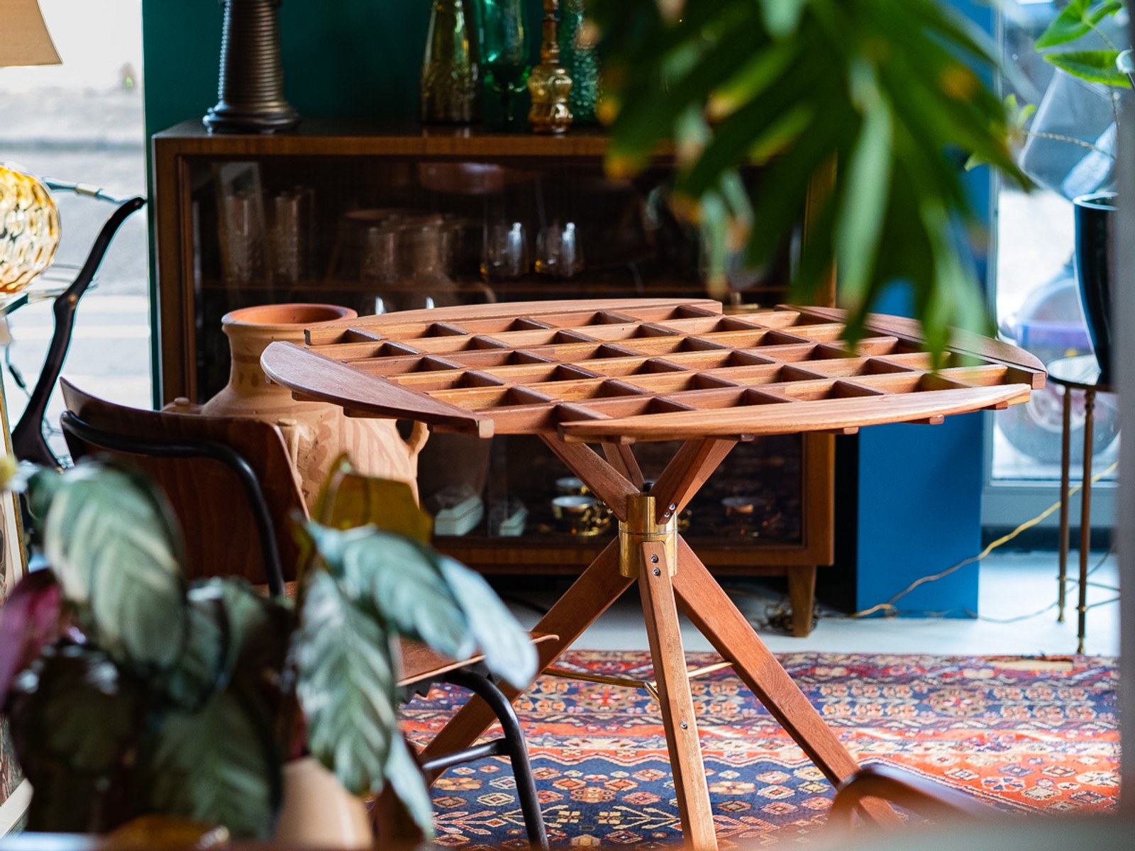 An Audience of Me — the table styled in a boutique interior, surrounded by ceramics and plants.