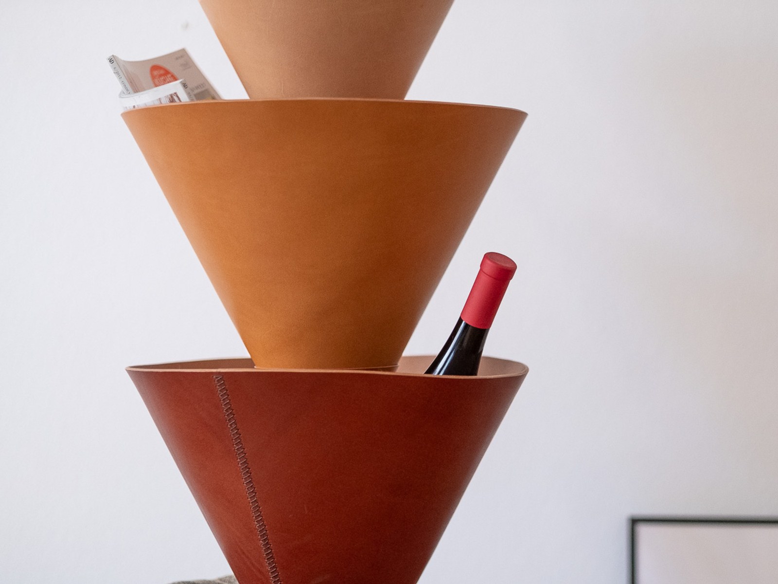 House Palm by NOEMAR — stylised palm-tree shelf of stacked leather cones on a central mast. Wiener Norm collection, 2026 
