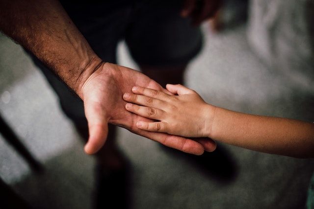 adult and child holding hands
