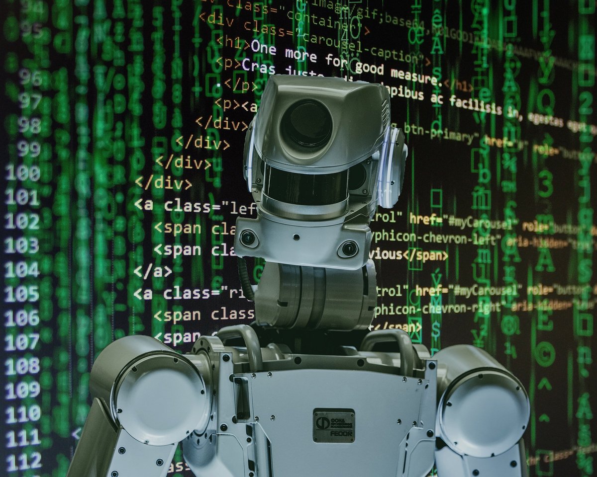 Humanoid robot in front of a screen full of green code, symbolising an AI agent in the supply chain attack path