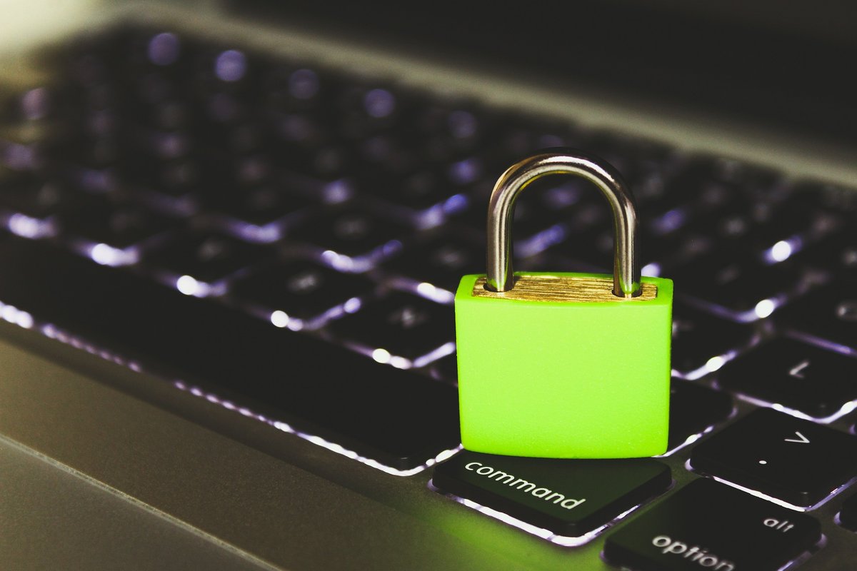 Green padlock on a laptop keyboard, symbolising identity and access management in the cloud
