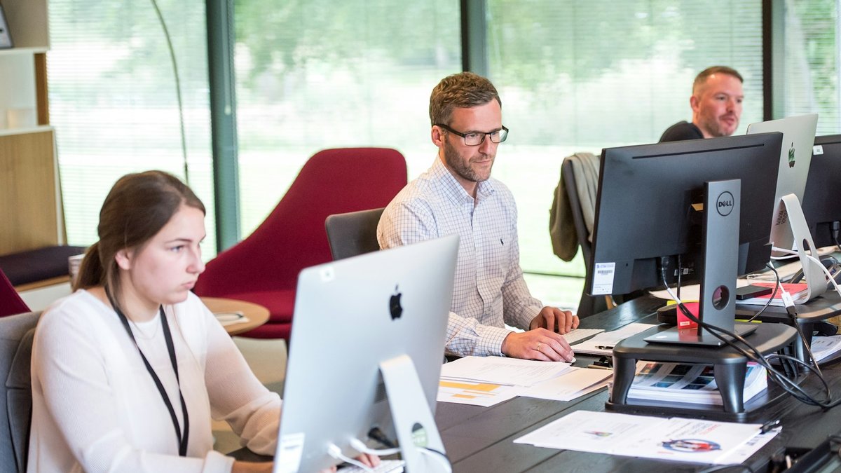 Colleagues working at computers in a bright office