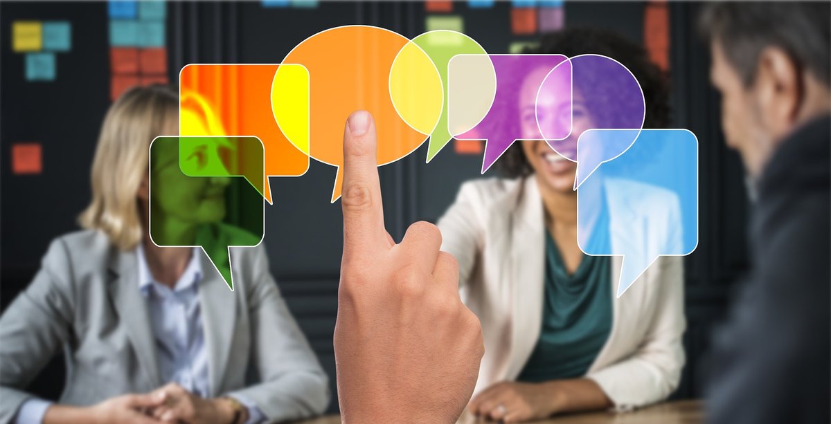 Employees pointing at colourful speech bubbles during an interactive security awareness session