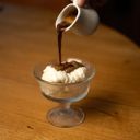 Versement d'un café chaud sur une coupe glacée affogato