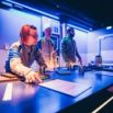 Escape game ambiance bleue avec joueurs concentrés
