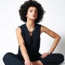 Femme assise tenue tailleur sans manches studio sobre