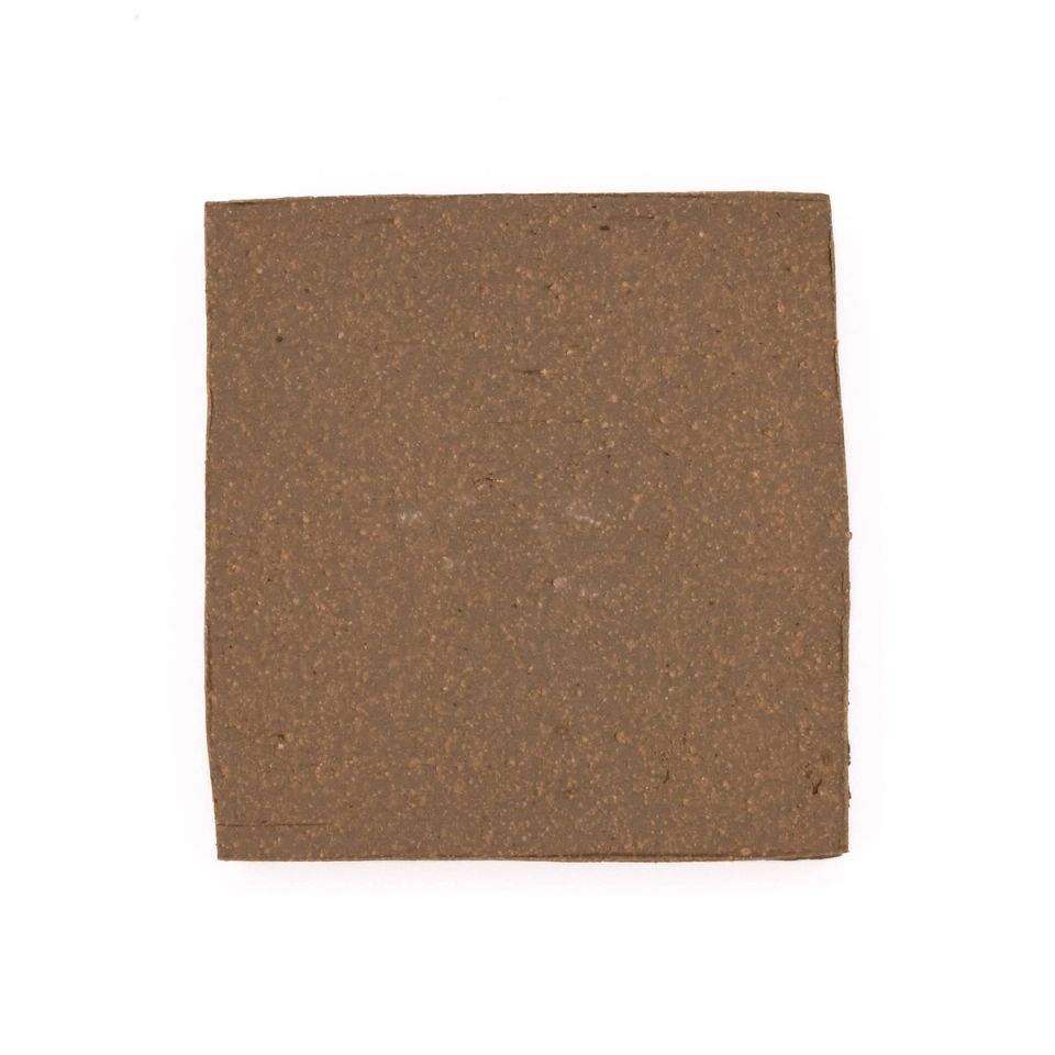 A square fired slab in warm mid-brown, its surface finely grainy and flecked with darker specks.