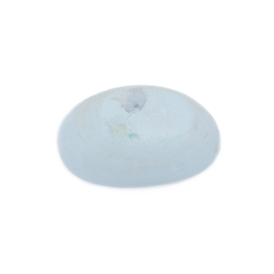 A small oval of pale blue-white foam, its surface smooth and slightly domed with a faint grey smudge.