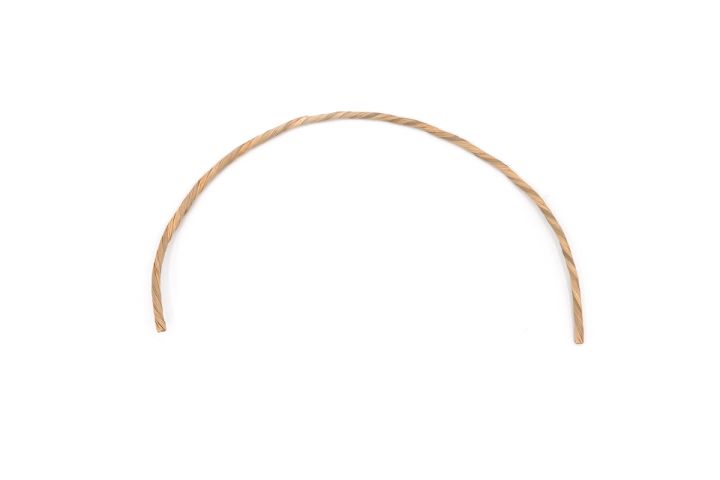 A single length of the cord bent into a wide arch, holding its curve and showing the tight spiral of the twist.