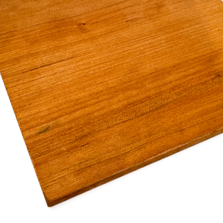 A close view of one corner, the glossy finished surface and fine straight grain filling the frame with the thin cut edge below.