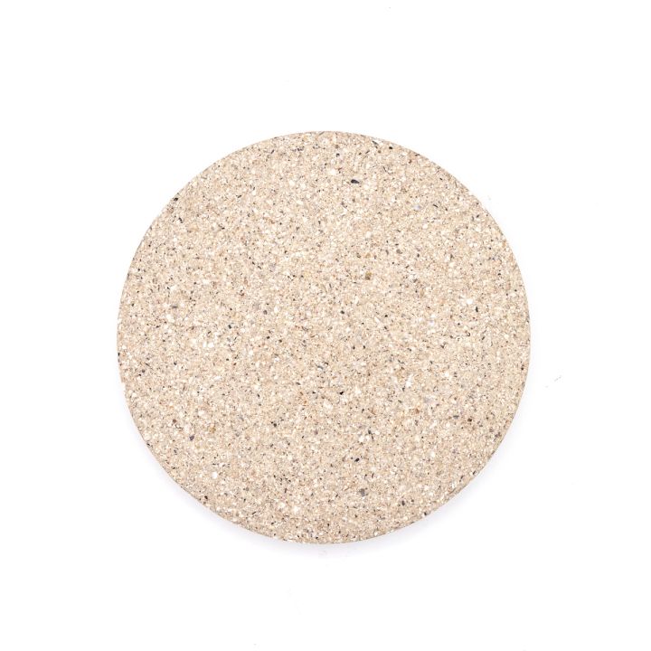 The tile face-on and evenly lit, its pale oatmeal surface finely and uniformly speckled.