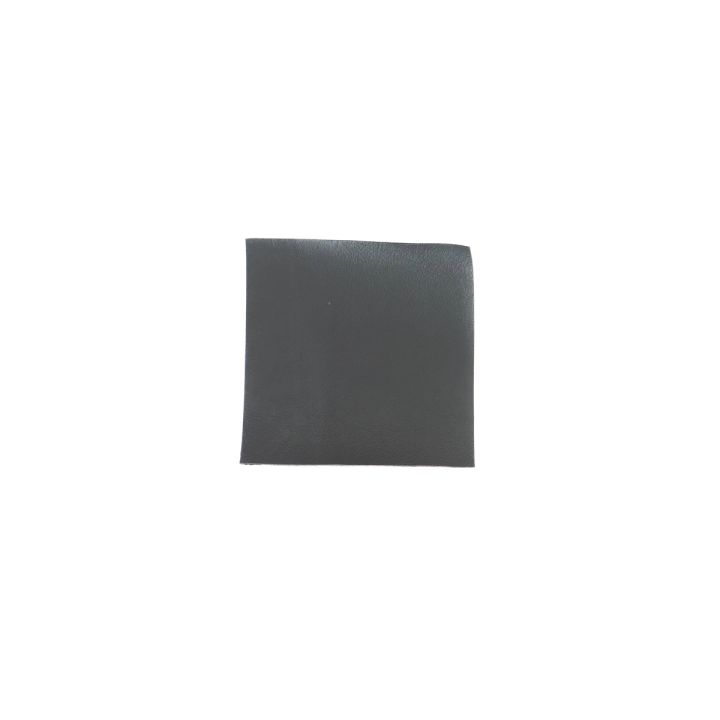 A single square in dark charcoal-teal on its own, showing the smooth matte face the fanned group hides.