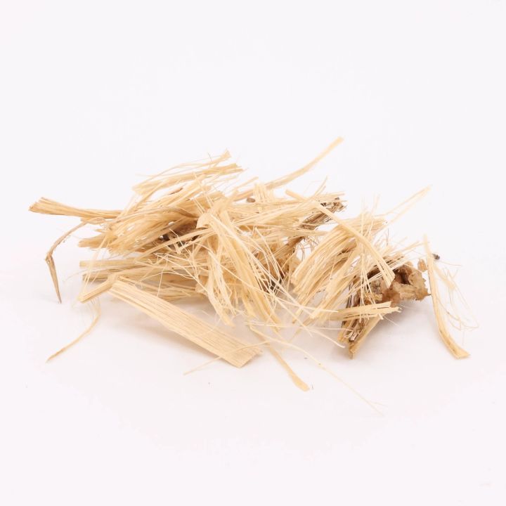 A small heap of short, splintered fibre in pale cream, the strips flat and frayed with woody fragments among them.