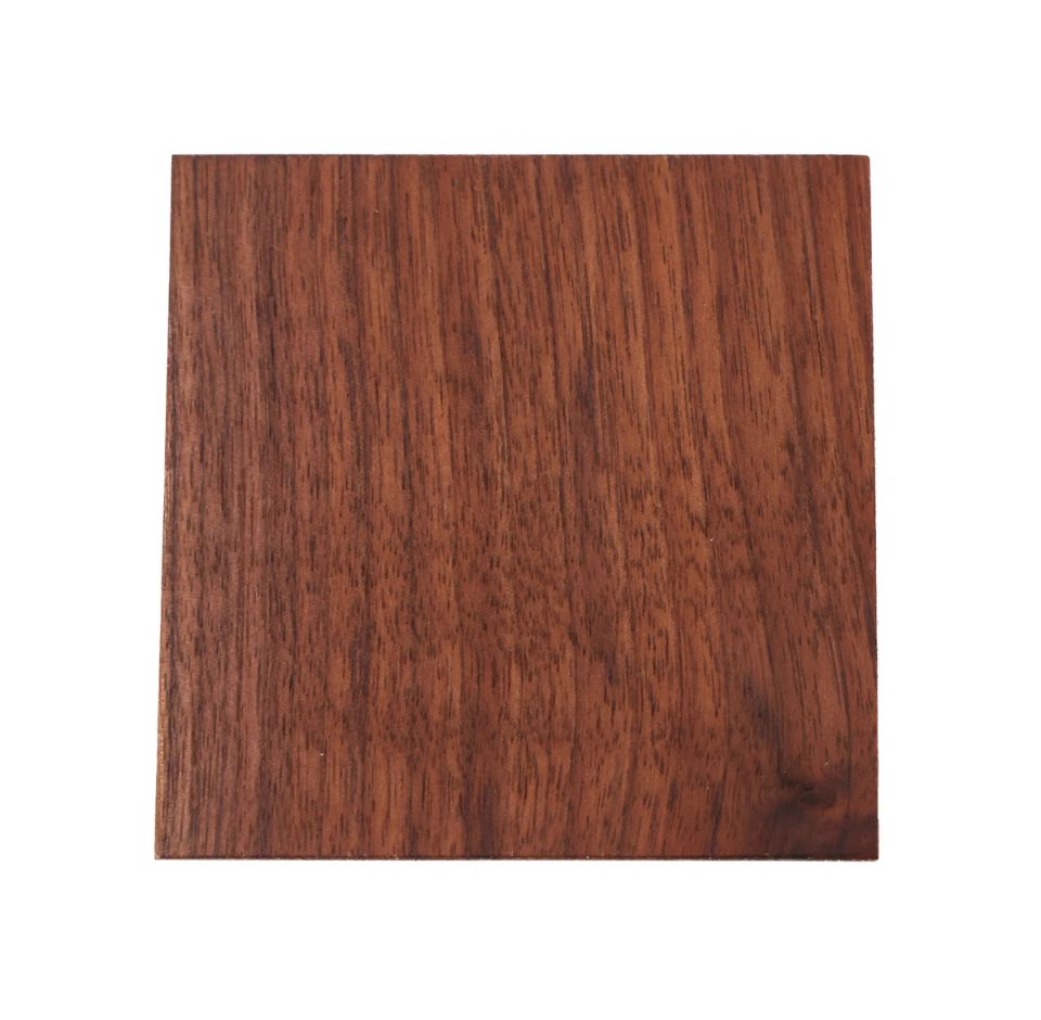 A square of black walnut, planed smooth, its grain running in straight dark chocolate stripes against a warmer red-brown ground.