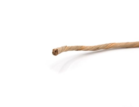 A twisted length of waxed paper cord in pale straw, its spiral wrap loosening into a frayed core at the cut end.