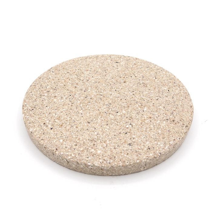 The tile at a slight angle, showing its face together with the shallow depth of its rim.