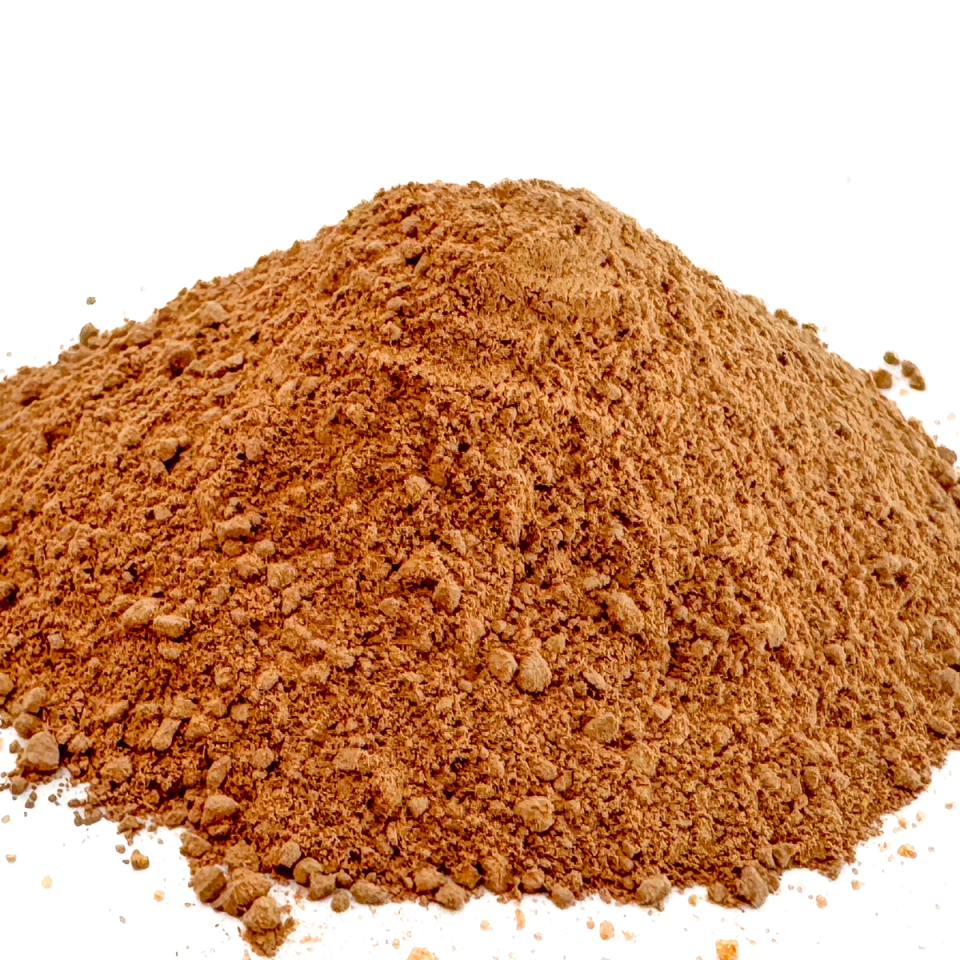 The powder heaped much higher and seen closer, its rust-orange grains coarse and lumpy with fines spilling down the slope.