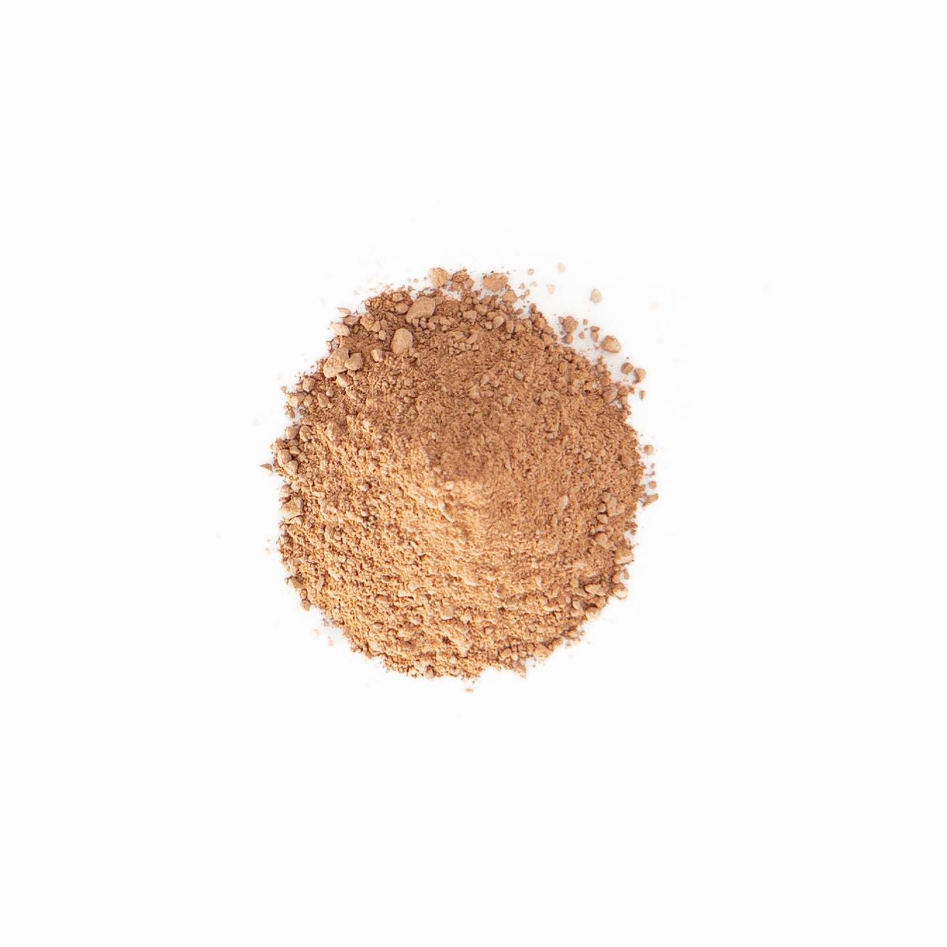 A small heap of dry clay powder in warm sandy orange, finely milled and softly mounded.