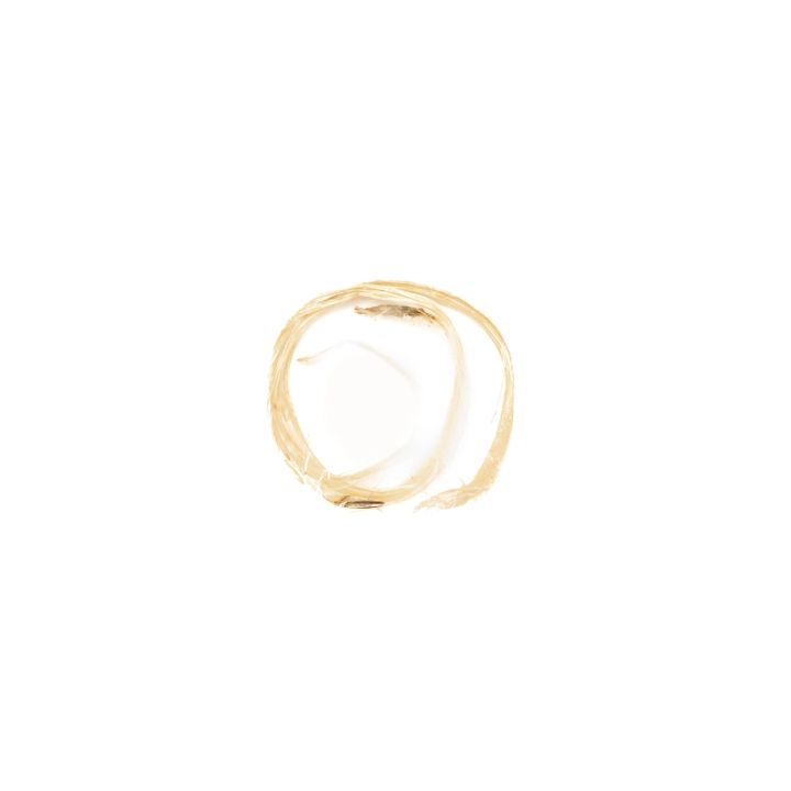 A single loop of the fibre lying alone, thin and pale, twisted into a small open circle.