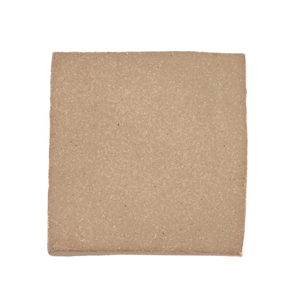 A square fired slab in soft grey-buff, its surface finely grainy with slightly rounded corners.