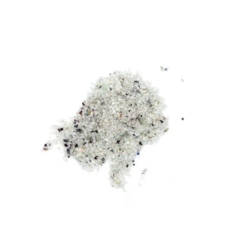 A scatter of crushed pale glass granules, mostly clear and frosted white with dark grey and coloured specks mixed through.