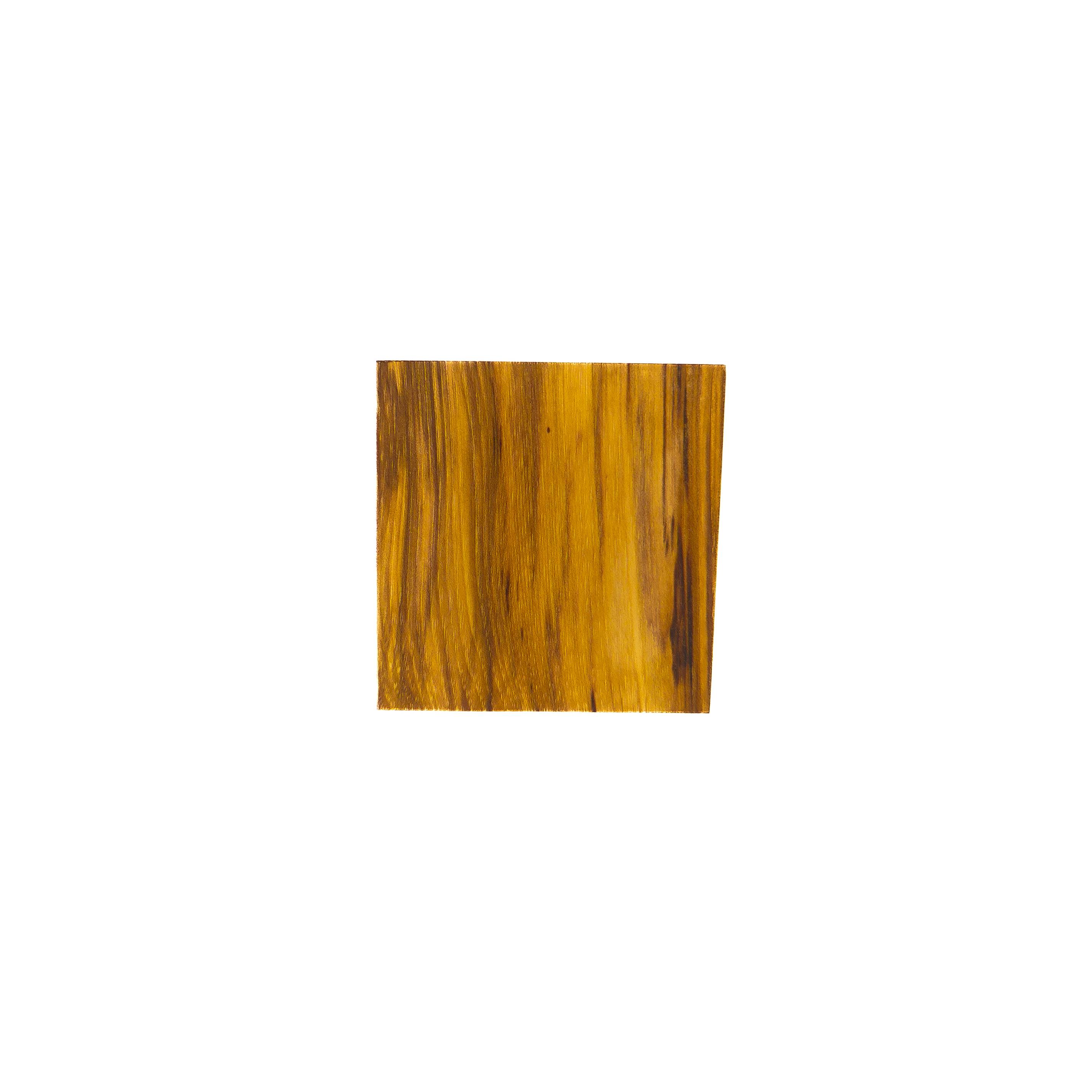 A small square of hickory in bright golden amber, streaked with darker olive-brown bands running vertically.