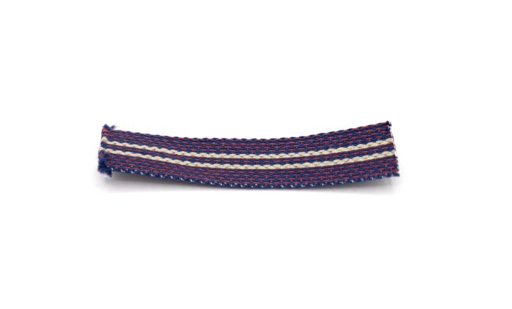 A short length of woven tape in navy and burgundy with a cream stripe down the centre, its cut ends fraying.