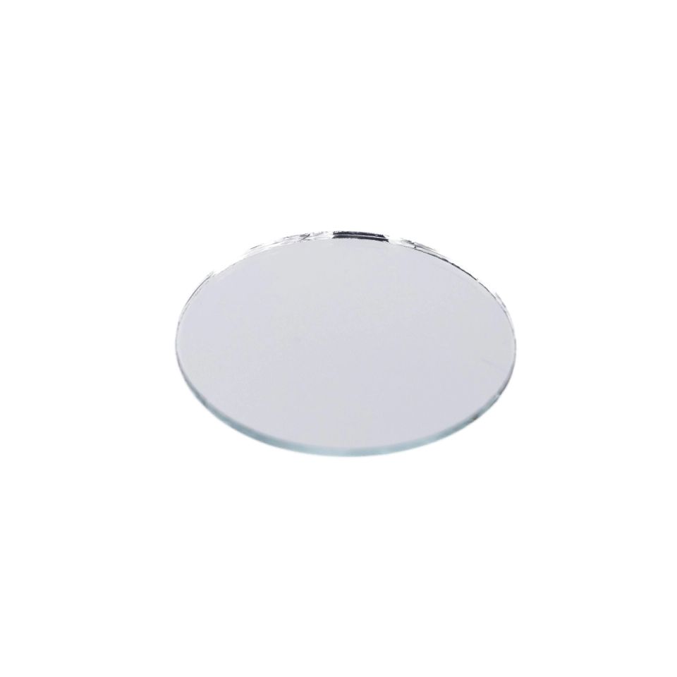 A small round mirror seen at a low angle, its silvered face reflecting flatly with a bright sliver of light along the top edge.