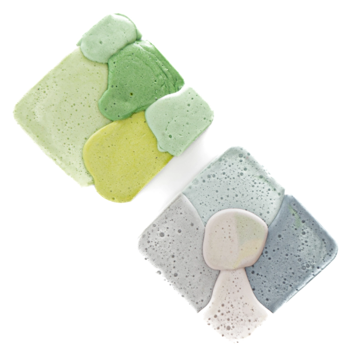 Two squares together — one in greens and yellow-green, one in blue-grey with a pale mushroom-shaped inset — both pitted with fine bubbles.