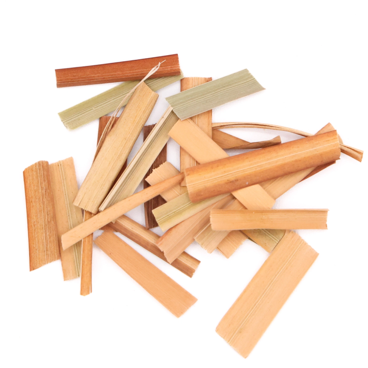 The leaves cut into short lengths and scattered loosely, their flat blades ranging from coral through to pale green.