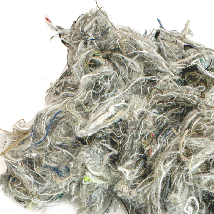 A close view of the fill, the grey fibres wiry and matted with coloured threads woven through them.