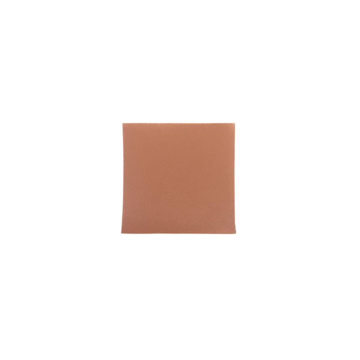 A single square in warm tan-brown on its own, its surface carrying a fine pebbled grain.