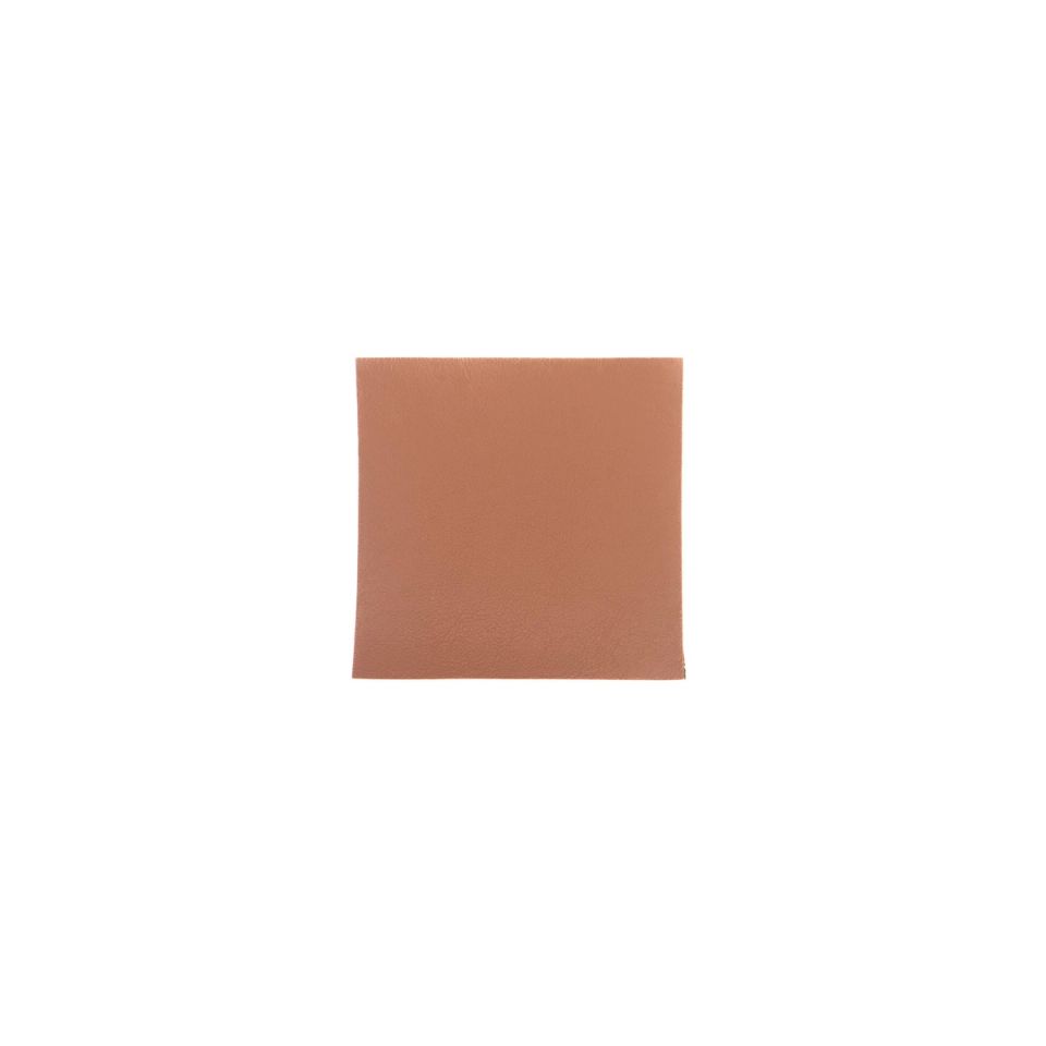 A single square in warm tan-brown on its own, its surface carrying a fine pebbled grain.