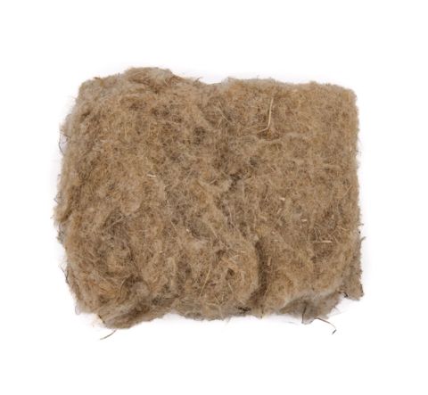 A thick square pad of hemp insulation in mottled tan, its surface a dense mat of coarse fibres with darker flecks throughout.