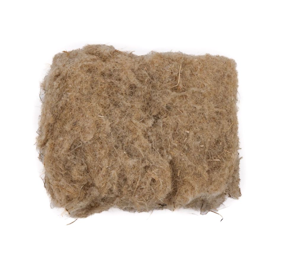 A thick square pad of hemp insulation in mottled tan, its surface a dense mat of coarse fibres with darker flecks throughout.