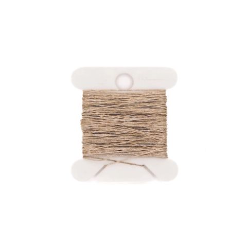 A small white spool wound with fine dark grey conductive thread, a loose loop of it trailing out across the surface.