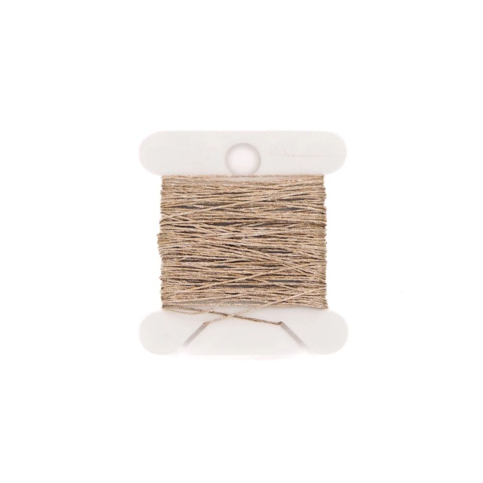 A small white spool wound with fine dark grey conductive thread, a loose loop of it trailing out across the surface.