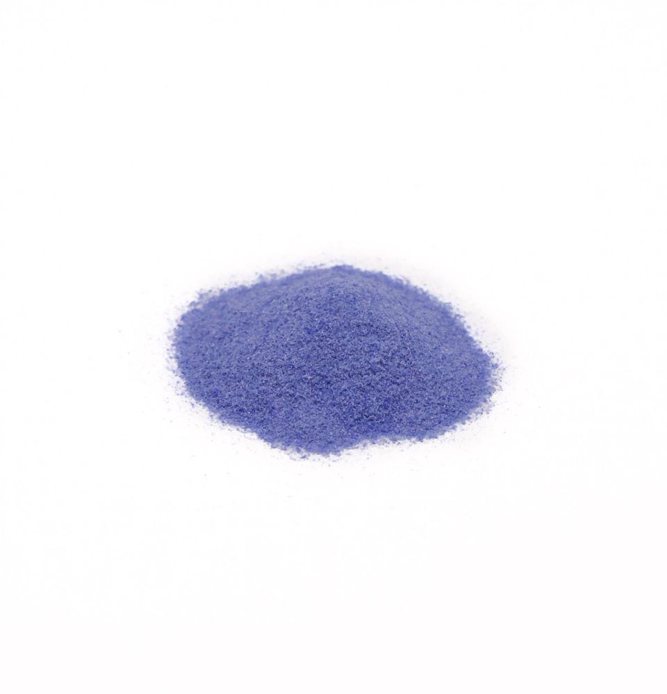 A neat mound of enamel powder in strong violet-blue, the grains fine and evenly sifted.