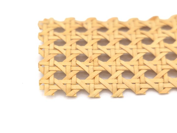 A close view of the webbing laid flat, its lattice of pale honey strands filling the frame in a regular hexagonal grid.