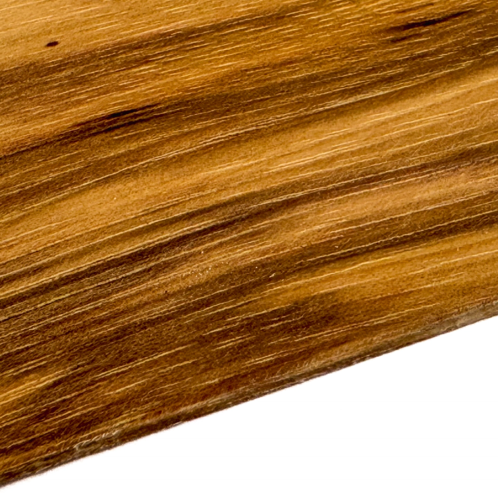 A close view of the grain, wide bands of golden amber and dark chocolate running diagonally with fine pale streaks between.