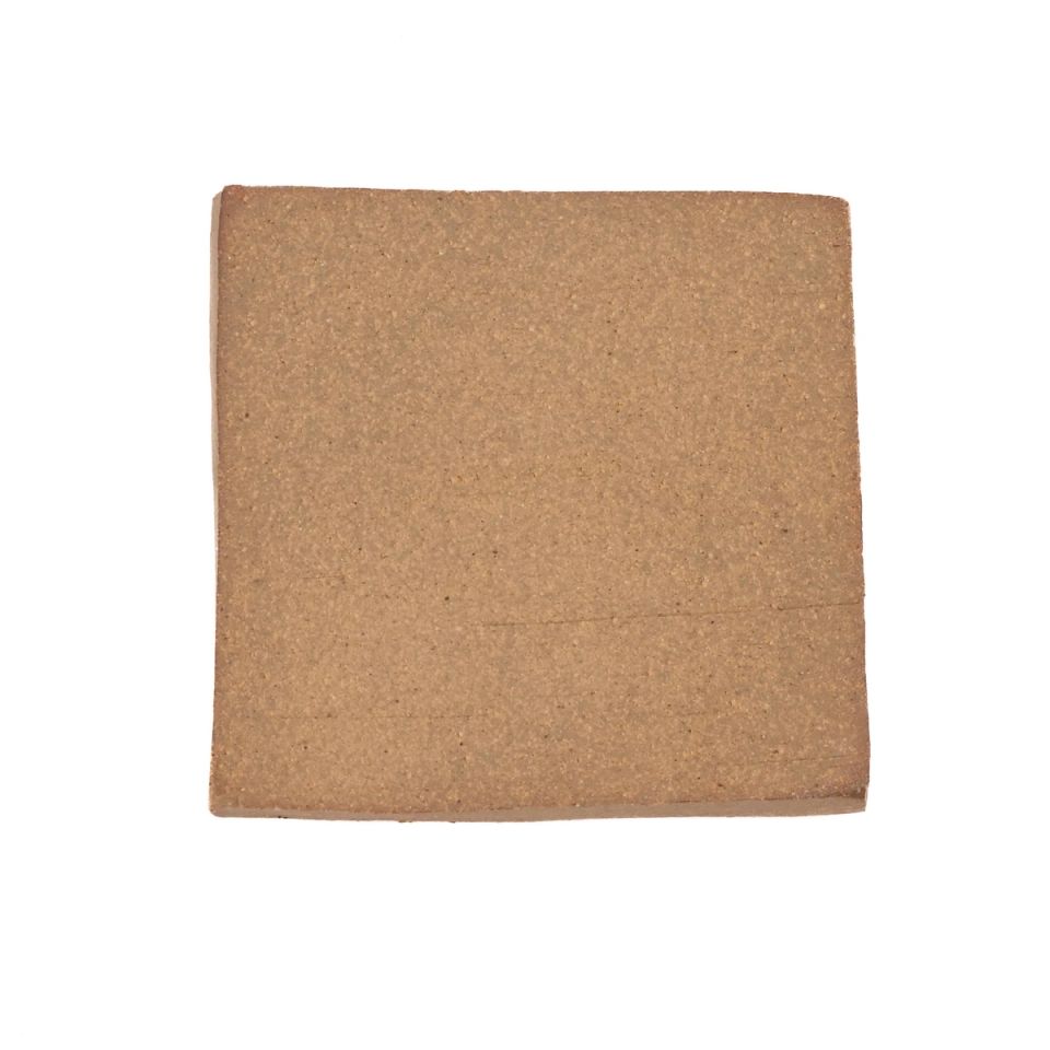 A square fired slab in warm terracotta brown, its surface finely grainy with faint tooling marks near the edges.