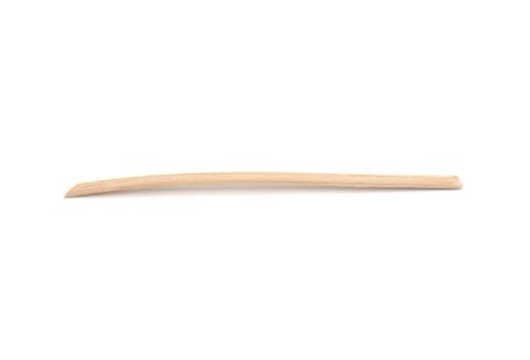 A single long ash splint lying almost flat, pale straw-coloured and tapering to a fine point at one end.