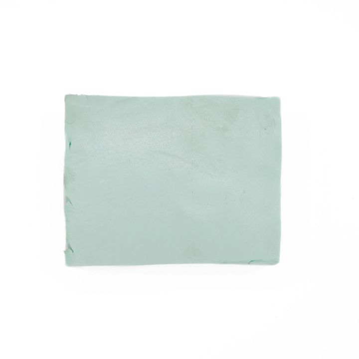 A smaller rectangle of the same pale mint foam seen flat-on, its surface plain and lightly scuffed.