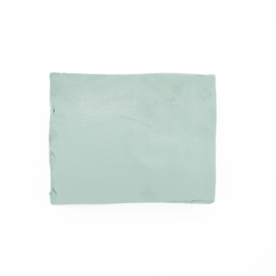 A smaller rectangle of the same pale mint foam seen flat-on, its surface plain and lightly scuffed.