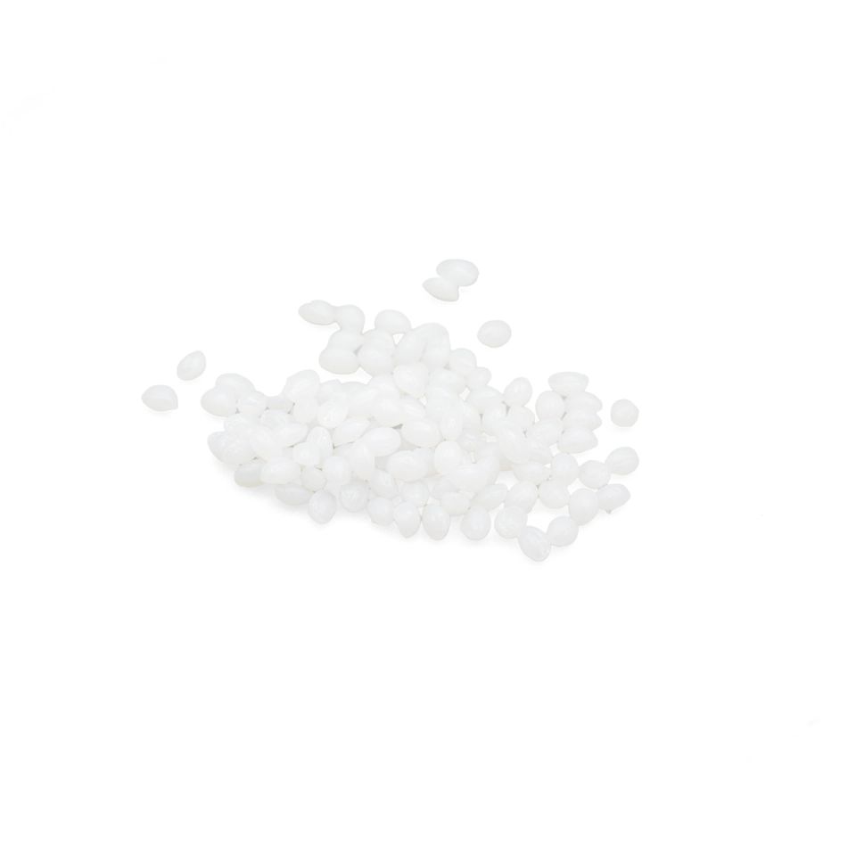 A scatter of small white plastic pellets, each an opaque rounded bead with a soft sheen.